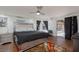 Spacious bedroom with a large bed, dark curtains, and access to an outdoor area at 1911 Venalynne St, Las Vegas, NV 89156
