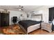 Bright bedroom with stylish bed, desk and chair, complemented by hardwood floors at 1911 Venalynne St, Las Vegas, NV 89156