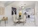 Bright dining room featuring a glass table, modern chandelier, and white walls at 1911 Venalynne St, Las Vegas, NV 89156