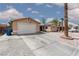 View of the home with long driveway and gravel landscaping at 1911 Venalynne St, Las Vegas, NV 89156