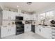 Updated kitchen with white cabinets, modern appliances, and quartz countertops at 1911 Venalynne St, Las Vegas, NV 89156