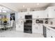 View of a renovated kitchen, with marble floors, white cabinets and stainless steel oven at 1911 Venalynne St, Las Vegas, NV 89156