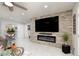 Stylish living room with stone accent wall, modern fireplace, and sleek tile flooring at 1911 Venalynne St, Las Vegas, NV 89156