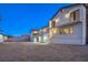 Exterior view of a home's back façade with balcony, patio area and a spacious backyard at 210 E Longacres Dr, Henderson, NV 89015