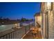 Cozy outdoor balcony with a table and chairs perfect for enjoying the fresh air and scenic views at 210 E Longacres Dr, Henderson, NV 89015
