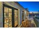Inviting balcony with French doors offering seamless indoor-outdoor living and neighborhood views at 210 E Longacres Dr, Henderson, NV 89015