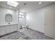 Bright bathroom featuring a vanity with drawers, toilet, and a skylight at 210 E Longacres Dr, Henderson, NV 89015