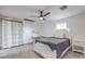 Cozy bedroom with a white bed frame, matching nightstand, and built-in shelving at 210 E Longacres Dr, Henderson, NV 89015