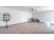 Large, versatile room with wood-style flooring, ceiling fan, and a work space at 210 E Longacres Dr, Henderson, NV 89015