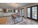 Elegant dining room adjacent to living area with access to outside patio at 210 E Longacres Dr, Henderson, NV 89015
