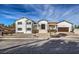 Striking two-story home boasts a grand entryway, charming covered porch, and convenient attached garage at 210 E Longacres Dr, Henderson, NV 89015