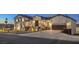 Elegant two-story home with a welcoming entrance, lush landscaping, and attached garage at 210 E Longacres Dr, Henderson, NV 89015