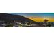 Scenic view of the neighborhood at sunset with surrounding houses and a mountain backdrop at 210 E Longacres Dr, Henderson, NV 89015