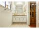 Bathroom with a large mirror and wooden cabinets at 2255 S Buffalo Dr, Las Vegas, NV 89117