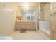 Bathroom showcasing a vanity, shower with a glass door, and a tiled floor at 2255 S Buffalo Dr, Las Vegas, NV 89117