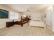 Large bedroom with multiple bed frames, a ceiling fan, and large windows at 2255 S Buffalo Dr, Las Vegas, NV 89117
