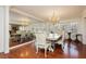 Formal dining room with a chandelier, mirrored wall, and a large table perfect for entertaining guests at 2255 S Buffalo Dr, Las Vegas, NV 89117