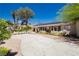 Spacious driveway, manicured landscaping, and large windows add curb appeal to this charming home at 2255 S Buffalo Dr, Las Vegas, NV 89117