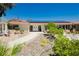 Inviting front yard with well-maintained landscaping, a brick walkway, and double door entry to the home at 2255 S Buffalo Dr, Las Vegas, NV 89117