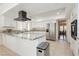 Modern kitchen featuring white cabinetry, stainless steel appliances, and a large center island at 2255 S Buffalo Dr, Las Vegas, NV 89117