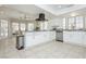 Bright kitchen featuring granite countertops, stainless steel appliances, and ample cabinet space at 2255 S Buffalo Dr, Las Vegas, NV 89117