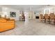 Open-concept living area with tile flooring, a fireplace, and a large sofa perfect for relaxing at 2255 S Buffalo Dr, Las Vegas, NV 89117