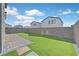 A spacious backyard showcasing manicured synthetic lawn, pavers, and block wall, offering lots of room for outdoor enjoyment at 2885 Timber Country Rd, North Las Vegas, NV 89086