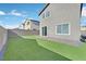Large backyard featuring synthetic lawn, pavers, and block wall, perfect for outdoor living and activities at 2885 Timber Country Rd, North Las Vegas, NV 89086