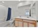 Bright bathroom with a double sink vanity, bathtub, shower and a large mirror at 2885 Timber Country Rd, North Las Vegas, NV 89086