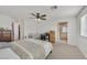 Bright bedroom featuring neutral decor, ceiling fan, and ensuite bathroom and closet at 2885 Timber Country Rd, North Las Vegas, NV 89086