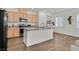 Modern kitchen with granite countertops, stainless steel appliances, and hardwood floors at 2885 Timber Country Rd, North Las Vegas, NV 89086