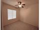 Neutral bedroom featuring a ceiling fan, tiled floor, and a window with horizontal blinds for ample natural light and privacy at 3004 Darby Falls Dr, Las Vegas, NV 89134