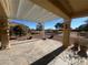 Inviting covered patio with stone flooring and view of the golf course and desert landscaping at 3004 Darby Falls Dr, Las Vegas, NV 89134