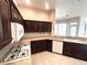 Traditional kitchen with granite countertops, dark wood cabinets, and white appliances at 3004 Darby Falls Dr, Las Vegas, NV 89134