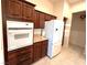 Modern kitchen featuring stainless steel appliances, granite countertops, and wooden cabinets at 3004 Darby Falls Dr, Las Vegas, NV 89134