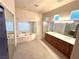 Spacious main bathroom featuring double vanities, shower, garden tub, and recessed lighting at 3004 Darby Falls Dr, Las Vegas, NV 89134