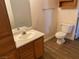 Standard bathroom includes a wood vanity, sink, and toilet with wood-look flooring at 311 Manti Pl # 311, Henderson, NV 89014