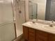 Bathroom with double sinks, shower with glass doors and tile surround, and ample lighting at 311 Manti Pl # 311, Henderson, NV 89014