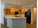 Efficient kitchen with wood cabinets, a gas cooktop, and a breakfast bar at 311 Manti Pl # 311, Henderson, NV 89014