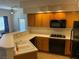 Well-lit kitchen featuring black appliances, a double sink, and a gas cooktop at 311 Manti Pl # 311, Henderson, NV 89014