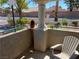 Small patio area with a chair, greenery and a view of the street and neighborhood at 311 Manti Pl # 311, Henderson, NV 89014