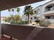 View from the balcony showcases the manicured grounds, lush trees, and building exterior in the community at 3125 N Buffalo Dr # 1080, Las Vegas, NV 89128