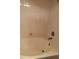 Bathroom featuring a large soaking tub with white tile surround at 3125 N Buffalo Dr # 1080, Las Vegas, NV 89128