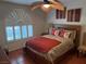 Cozy bedroom featuring a ceiling fan, shuttered windows, and comfortable furnishings at 3125 N Buffalo Dr # 1080, Las Vegas, NV 89128