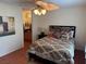 Cozy bedroom featuring a ceiling fan, shuttered windows, and comfortable furnishings with bathroom access at 3125 N Buffalo Dr # 1080, Las Vegas, NV 89128