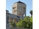 Close-up view of the clock tower above retail shops in a commercial area featuring terracotta tile roof at 3125 N Buffalo Dr # 1080, Las Vegas, NV 89128