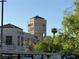 Exterior view of a commercial building featuring upscale retail shops and an iconic clock tower at 3125 N Buffalo Dr # 1080, Las Vegas, NV 89128