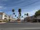 View of the Mar-A-Lago community entrance lined with palm trees under a clear blue sky at 3125 N Buffalo Dr # 1080, Las Vegas, NV 89128
