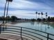 View of community featuring sandy beach leading into a lake and palm trees under a bright sky at 3125 N Buffalo Dr # 1080, Las Vegas, NV 89128