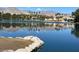 Scenic lake view showcasing the community buildings, palm trees, and mountains in the background on a sunny day at 3125 N Buffalo Dr # 1080, Las Vegas, NV 89128